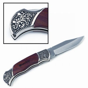 May include: A pocket knife with a stainless steel blade and a handle made of dark wood. The handle is accented with ornate silver-colored metal detailing. The name "Bucky" is engraved on the wooden handle.