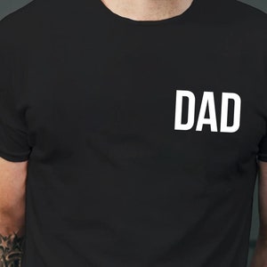 May include: Black t-shirt with the word "DAD" printed in white on the front.