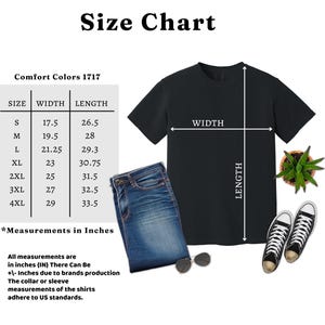 May include: A black t-shirt size chart for Comfort Colors 1717, displaying width and length measurements in inches for sizes S through 4XL. The graphic includes a black t-shirt, blue jeans, sunglasses, a small succulent plant, and black sneakers.