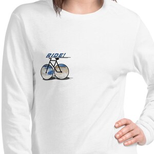 May include: White long-sleeve t-shirt with a graphic of a bicycle with the word "RIDE!" above it.