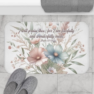 May include: A white bath mat with a floral design and the text "I will praise thee; for I am fearfully and wonderfully made. Psalm 139:14".