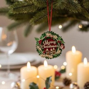 May include: A festive Christmas scene featuring a decorative ornament with "Merry Christmas" text, hanging from a pine branch. Lit candles and holiday decor, including berries and pinecones, create a warm, inviting atmosphere.