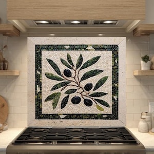May include: A kitchen backsplash featuring a mosaic tile design of an olive branch with green leaves and black olives. The mosaic is framed with a dark green border. The kitchen has light-colored cabinets and a stainless steel stove.
