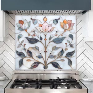 May include: A decorative kitchen backsplash with a floral design. The backsplash features a white background with a detailed pattern of pink, orange, and blue flowers and leaves. The kitchen has white cabinets, a stainless steel stove, and a dark blue range hood.