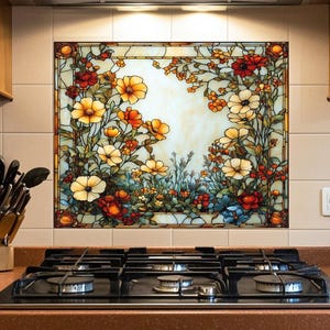 May include: A decorative kitchen backsplash featuring a stained-glass floral design. The artwork showcases a variety of flowers in shades of yellow, orange, red, and blue, framed by a dark border. The backsplash is installed above a gas stove.