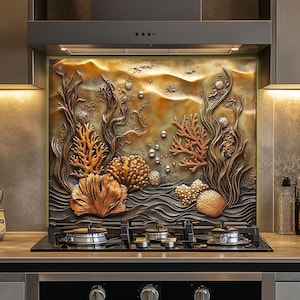 May include: A kitchen backsplash with a 3D relief design depicting an underwater scene. The artwork features coral, seaweed, and bubbles in shades of brown, orange, and gold. The backsplash is installed above a gas stovetop and below a range hood.