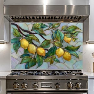 May include: A decorative kitchen backsplash featuring a stained glass design of lemons and leaves on a branch. The lemons are yellow, and the leaves are green. The background is a mix of light blue and white.
