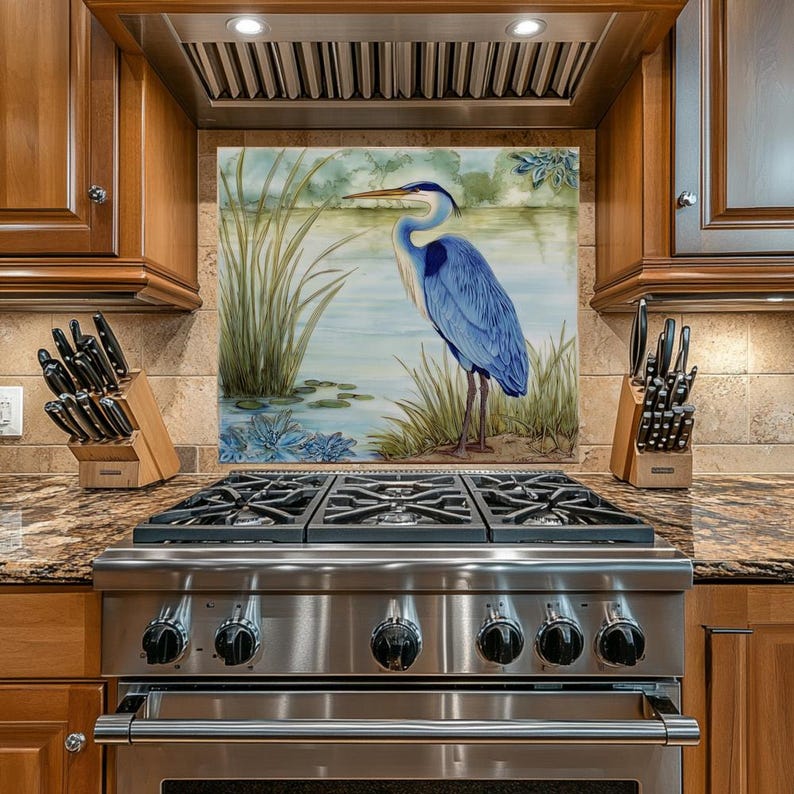 May include: A stainless steel gas range with six burners and a decorative backsplash featuring a blue heron standing in a marsh. The kitchen has wooden cabinets and a granite countertop.