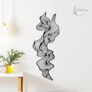 Può includere: Arte murale astratta in bianco e nero. L'opera presenta una forma organica e fluida composta da numerose linee parallele. È montata su una parete bianca, creando un contrasto suggestivo. Il design evoca un senso di movimento e fluidità.