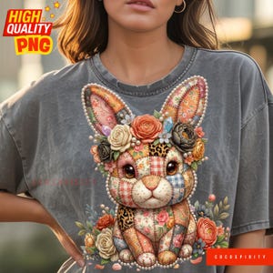 May include: A gray t-shirt featuring a patchwork bunny design with floral accents. The bunny has a variety of patterned fabrics, including floral, plaid, and leopard print. The bunny is adorned with a floral crown and surrounded by flowers. The text "HIGH QUALITY PNG" is in the upper left corner.