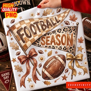 May include: A white fabric print featuring two pennants with the text FOOTBALL SEASON in brown. The design includes brown and tan checkered and leopard patterns, brown ribbons, a brown football, autumn leaves, small flowers, and stars.