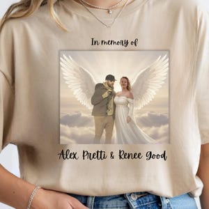 May include: Beige t-shirt featuring a memorial graphic. The graphic includes a couple with angel wings, set against a cloudy sky, with the text "In memory of Alex Pretti & Renee Good."