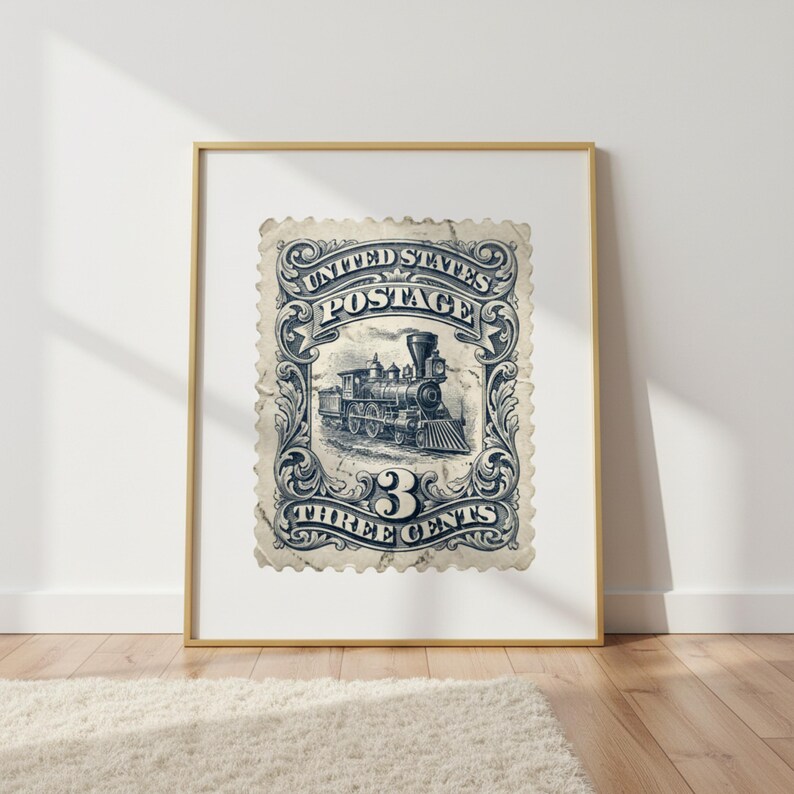May include: Framed vintage postage stamp print featuring a detailed illustration of a steam train. The stamp reads "United States Postage" and "Three Cents" in a decorative border. The print is in shades of blue and white.