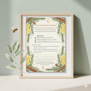 May include: A framed print with the text "THE ABUNDANCE HEARTH" and a recipe for a citrus and spice blend. The recipe includes sliced orange, cinnamon sticks, and cloves. Decorative elements include bees, rosemary, and crescent moons.