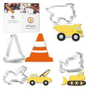 May include: Set of 7 construction themed cookie cutters. The cutters are made of metal and include a dump truck, a tow truck, a bulldozer, a backhoe, a traffic cone, and two different types of construction signs.