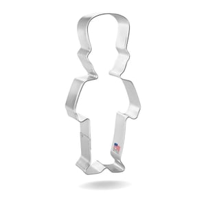 May include: A silver-colored cookie cutter in the shape of a person. The cutter has a simple design with a head, shoulders, torso, and legs. The words "Made in the USA" are printed on the bottom.
