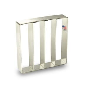 May include: A silver metal baking pan with four rectangular compartments. The pan is made in the USA.