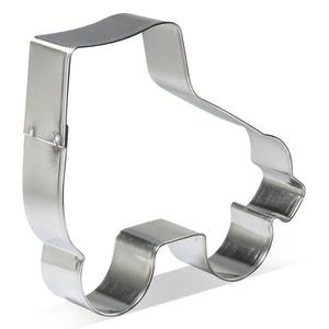 May include: A shiny, silver-colored cookie cutter in the shape of a roller skate. The cutter is made of metal and has a simple, clean design. The roller skate shape is complete with wheels and a boot.