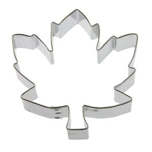 May include: A silver metal cookie cutter shaped like a maple leaf.