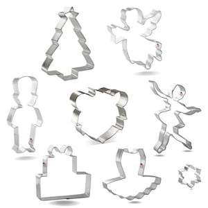 May include: Set of nine metal cookie cutters in various shapes, including a Christmas tree, angel, ballerina, snowflake, gift box, and a bear. The cutters are silver and have a shiny finish.
