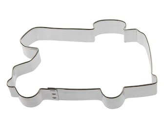 May include: A silver metal cookie cutter shaped like a vintage delivery truck.