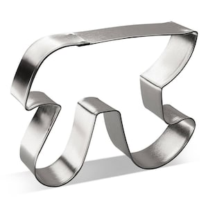 May include: A silver metal cookie cutter shaped like the mathematical symbol pi.