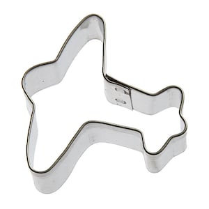 May include: A silver metal cookie cutter shaped like an airplane.