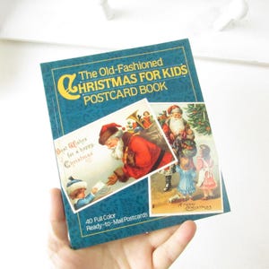 May include: A blue book with the title "The Old-Fashioned Christmas for Kids Postcard Book" and a picture of a Santa Claus on the cover. The book has 40 full-color, ready-to-mail postcards.