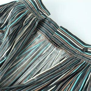 May include: A black, brown, and teal striped skirt with a button closure at the back.