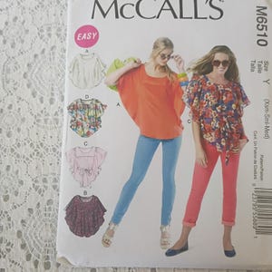 May include: A McCall's M6510 sewing pattern envelope for a loose-fitting top with four variations. The cover features illustrations of the designs and photographs of two tops: one solid orange and one floral print with a tie-waist detail.