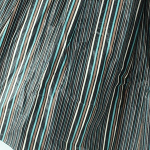 May include: A close-up of a fabric with vertical stripes in black, brown, white, and teal.