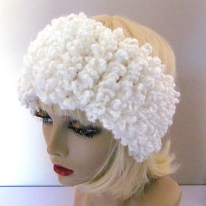 May include: White crocheted headband with a fluffy texture. The headband is wide and covers the ears.