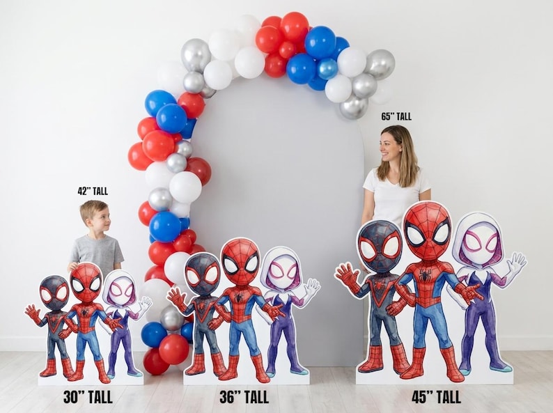 May include: A party decoration set featuring Spider-Man character cutouts, ranging from 30 to 45 inches tall, with a balloon arch. The arch is composed of red, white, silver, and blue balloons. A woman and a child are visible in the background.