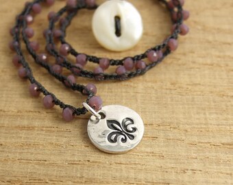 Crocheted Necklace with a Dark Gray Cord, Tiny, Milky Mauve, Crystal Beads and a Round, PMC Pendant with a Fleur De Lis Design SN-352