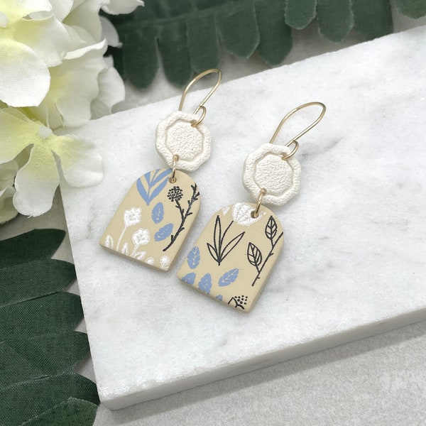 Earrings made with Beige Polymer Clay Arches Painted with White, Blue and Black Flowers and Leaves on 14k Gold Filled Earring Wires PCE-649