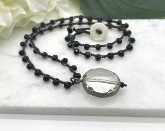 Crocheted Necklace with a Dark Gray Cord, Black Crystal Beads and a Pendant with an Oval, Clear Crystal Bead SN-599