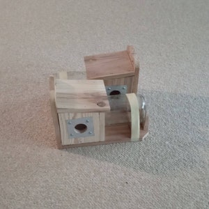 May include: Two wooden birdhouses with a glass jar attached to the side. The birdhouses are made of natural wood and have a simple design. The jar is clear glass and has a metal lid.