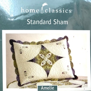 May include: A Home Classics standard sham pillow cover featuring a cream-coloured base with a central diamond-shaped patch in shades of green and purple. The sham has a scalloped edge and small floral embroidery accents in the corners.