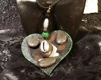 Wood Heart shape with mounted  Camouflage fabric with.mounted riverstones and centered Cowrie shell necklace