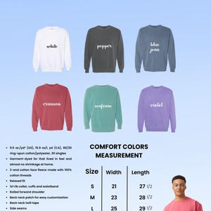 May include: A selection of Comfort Colors sweatshirts in various hues, including white, pepper, blue jean, crimson, seafoam, and violet. The image also displays size and measurement details for each sweatshirt.