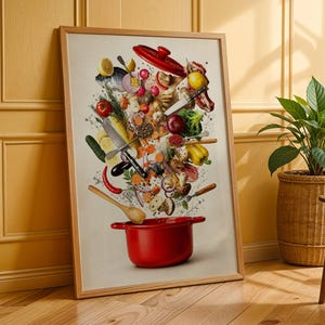 May include: A framed wall art print featuring a vibrant culinary scene with a red cooking pot at the bottom. Various fresh ingredients like lemons, tomatoes, broccoli, mushrooms, and peppers, along with kitchen knives and a wooden spoon, float upward.