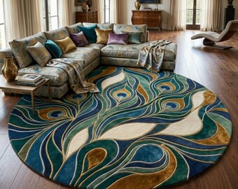 May include: A round area rug with a peacock feather design in shades of blue, green, and gold. The rug is placed on a hardwood floor in a living room setting. A sectional sofa and pillows are visible.