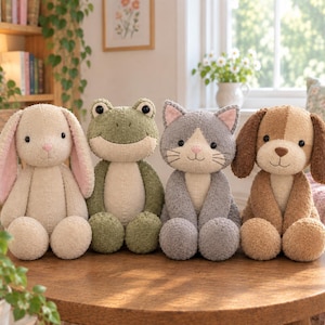 Könnte beinhalten: Ein Set aus vier Plüschtieren, die in einer Reihe sitzen, darunter ein beigefarbener Hase mit rosa Innenohren, ein grüner Frosch, eine graue Katze mit rosa Innenohren und ein brauner Hund. Jedes Tier hat gestickte Details und einen weichen Stoff.