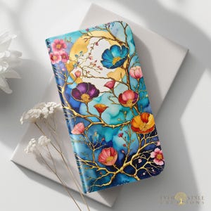 May include: A rectangular wallet featuring a vibrant watercolor-style print of golden branches, colorful flowers in shades of pink, purple, blue, and orange, and a large yellow moon against a deep blue background. The text Ever Style Creations is visible.