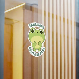 May include: A green frog sticker with the text "Sana Sana Colita de Rana" in a circle around it. The frog is smiling and has its hands up in the air.