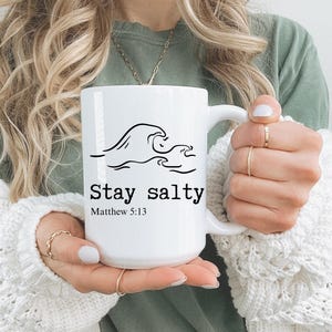 May include: White ceramic mug with a black wave design and the text "Stay salty" and "Matthew 5:13".