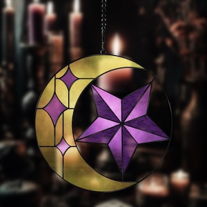 May include: A stained glass suncatcher featuring a crescent moon with a purple star inside. The moon is gold with a geometric pattern and the star has a purple and pink gradient.