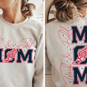 May include: Gray sweatshirt with the text "Track & Field MOM" in navy blue and red. The "O" in MOM is a red running shoe with wings.