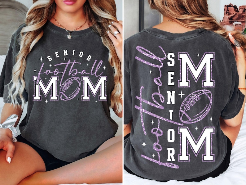 May include: Dark gray t-shirt with the words "SENIOR football MOM" in white and purple glitter. The front of the shirt features a football graphic. The back of the shirt has the words "Love the SENIOR football MOM" in purple glitter.