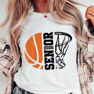 May include: White t-shirt with a black and orange basketball graphic and the text "Senior 2026".